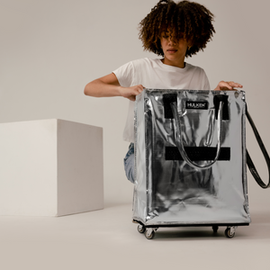 Person organizing essentials into a Hulken tote bag